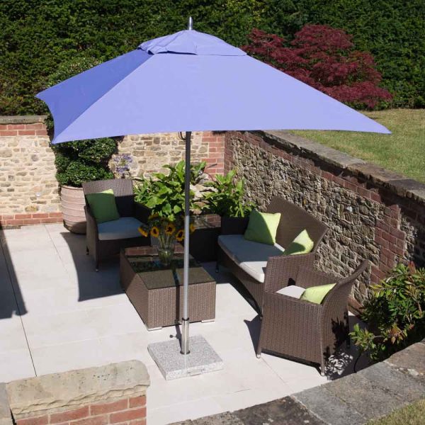 Tradewinds ALUZONE 2.2m square parasol with lilac canvas, with birds eye view of terrace setting with flint walls